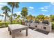 Community grilling area with multiple grills and a large table at 5855 Midnight Pass Rd # 311, Sarasota, FL 34242