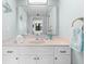 Bright bathroom boasts a vanity with a large mirror and updated fixtures at 5855 Midnight Pass Rd # 311, Sarasota, FL 34242