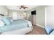 Spacious bedroom with king bed, dresser, and TV at 5855 Midnight Pass Rd # 311, Sarasota, FL 34242