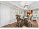 Dining area with wicker chairs and glass-top table, kitchen view at 5855 Midnight Pass Rd # 311, Sarasota, FL 34242