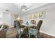 Dining area with wicker chairs and glass-top table at 5855 Midnight Pass Rd # 311, Sarasota, FL 34242
