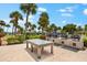 Outdoor grilling area with multiple grills and a large table at 5855 Midnight Pass Rd # 311, Sarasota, FL 34242
