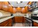 Well-equipped kitchen with wood cabinets, granite counters, and stainless steel appliances at 5855 Midnight Pass Rd # 311, Sarasota, FL 34242