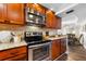Well-equipped kitchen with wood cabinets, granite counters, and stainless steel appliances at 5855 Midnight Pass Rd # 311, Sarasota, FL 34242