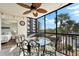 Bright lanai with table and chairs, offering screened-in outdoor dining space at 5855 Midnight Pass Rd # 311, Sarasota, FL 34242