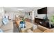 Living room with comfortable seating, hardwood floors, and flat-screen TV at 5855 Midnight Pass Rd # 311, Sarasota, FL 34242