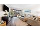 Spacious living room with large TV, comfortable seating, and hardwood floors at 5855 Midnight Pass Rd # 311, Sarasota, FL 34242