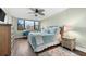 King-size bed, ceiling fan, and hardwood floors in main bedroom at 5855 Midnight Pass Rd # 311, Sarasota, FL 34242