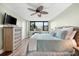 Main bedroom with king-size bed, hardwood floors, and large window at 5855 Midnight Pass Rd # 311, Sarasota, FL 34242