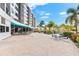 Outdoor patio area with seating and views of the pool and landscaping at 5855 Midnight Pass Rd # 311, Sarasota, FL 34242