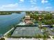 Aerial view of community tennis courts near waterfront at 5855 Midnight Pass Rd # 311, Sarasota, FL 34242