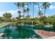 Tranquil waterfall feature with lush tropical plants at 5855 Midnight Pass Rd # 311, Sarasota, FL 34242