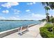 Scenic walkway along the waterfront with benches at 5855 Midnight Pass Rd # 311, Sarasota, FL 34242
