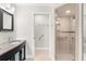 Bathroom with dual vanity, walk-in shower, and grab bars at 5916 Bonaventure Pl, Sarasota, FL 34243