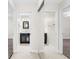 Clean bathroom with dark vanity, tiled floor and mirrored closet at 5916 Bonaventure Pl, Sarasota, FL 34243