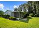 Home's exterior showcases a screened porch and landscaped yard at 5916 Bonaventure Pl, Sarasota, FL 34243