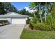 Two-car garage with paved driveway and well-manicured lawn at 5916 Bonaventure Pl, Sarasota, FL 34243