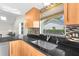 Modern kitchen with stainless steel appliances and wood cabinets at 5916 Bonaventure Pl, Sarasota, FL 34243