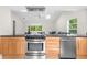 Modern kitchen with stainless steel appliances and wood cabinets at 5916 Bonaventure Pl, Sarasota, FL 34243
