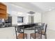 Modern kitchen features a breakfast bar with black countertops and wood cabinets at 5916 Bonaventure Pl, Sarasota, FL 34243