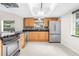 Modern kitchen with stainless steel appliances and wood cabinets at 5916 Bonaventure Pl, Sarasota, FL 34243