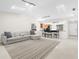 Bright living room featuring a sectional sofa and large rug at 5916 Bonaventure Pl, Sarasota, FL 34243