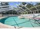 Community pool with a screened enclosure and seating area at 5916 Bonaventure Pl, Sarasota, FL 34243