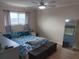 Main bedroom with comfortable bed and full-length mirror at 6033 34Th W St # 138, Bradenton, FL 34210