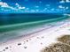 Aerial view of a beautiful beach with people enjoying the sun at 6300 Midnight Pass Rd # 708, Sarasota, FL 34242