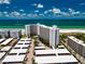 Aerial view of a beachfront condominium complex with parking and ocean views at 6300 Midnight Pass Rd # 708, Sarasota, FL 34242