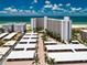 Aerial view of beachfront condo building with parking and ocean views at 6300 Midnight Pass Rd # 708, Sarasota, FL 34242