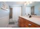 Updated bathroom with wood cabinets and a shower/tub combo at 6300 Midnight Pass Rd # 708, Sarasota, FL 34242