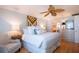 Spacious bedroom with king bed and ceiling fan at 6300 Midnight Pass Rd # 708, Sarasota, FL 34242
