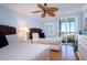 Well-lit bedroom featuring twin beds and a balcony at 6300 Midnight Pass Rd # 708, Sarasota, FL 34242