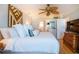 King bed, ceiling fan, coastal decor at 6300 Midnight Pass Rd # 708, Sarasota, FL 34242