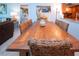 Elegant dining area with a rustic wood table and wicker chairs at 6300 Midnight Pass Rd # 708, Sarasota, FL 34242