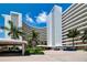 Oceanfront condo building with palm trees and courtyard at 6300 Midnight Pass Rd # 708, Sarasota, FL 34242
