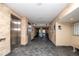 Building hallway with elevators and tiled floors at 6300 Midnight Pass Rd # 708, Sarasota, FL 34242