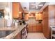 Well-equipped kitchen featuring granite countertops and wood cabinets at 6300 Midnight Pass Rd # 708, Sarasota, FL 34242