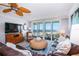 Living room with ocean view, comfortable seating, and large TV at 6300 Midnight Pass Rd # 708, Sarasota, FL 34242