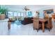Bright living room with ocean view, leather sofas, and wicker chairs at 6300 Midnight Pass Rd # 708, Sarasota, FL 34242