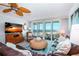 Living room with ocean view, comfortable seating, and large TV at 6300 Midnight Pass Rd # 708, Sarasota, FL 34242