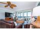Living room with ocean view, comfortable seating, and large TV at 6300 Midnight Pass Rd # 708, Sarasota, FL 34242
