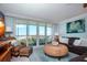 Living room boasts ocean view, leather sofas, and wicker armchairs at 6300 Midnight Pass Rd # 708, Sarasota, FL 34242