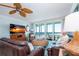 Living room with ocean view, comfortable seating, and large TV at 6300 Midnight Pass Rd # 708, Sarasota, FL 34242