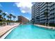 Refreshing kidney-shaped pool with lounge chairs at 6300 Midnight Pass Rd # 708, Sarasota, FL 34242