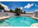 Sparkling kidney-shaped pool with lounge chairs and palm trees at 6300 Midnight Pass Rd # 708, Sarasota, FL 34242