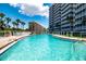 Inviting kidney-shaped swimming pool with surrounding lounge chairs at 6300 Midnight Pass Rd # 708, Sarasota, FL 34242