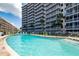 Refreshing kidney-shaped pool with surrounding lounge chairs at 6300 Midnight Pass Rd # 708, Sarasota, FL 34242