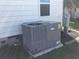 Grey central AC unit on a concrete slab at 763 Lakeside Dr, North Port, FL 34287